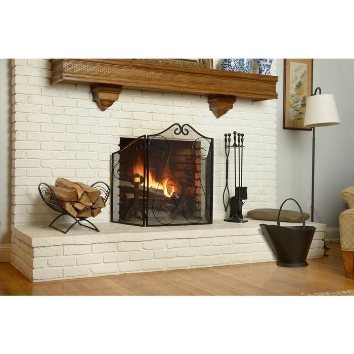 a white brick fireplace with logs in it