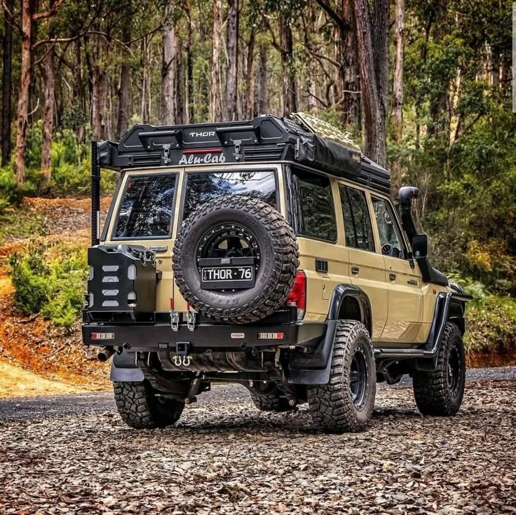 an off - road vehicle is parked in the woods