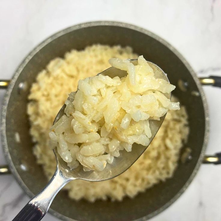 a spoon full of rice in a pot