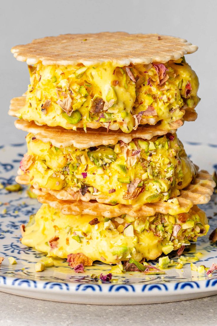 a stack of food sitting on top of a blue and white plate