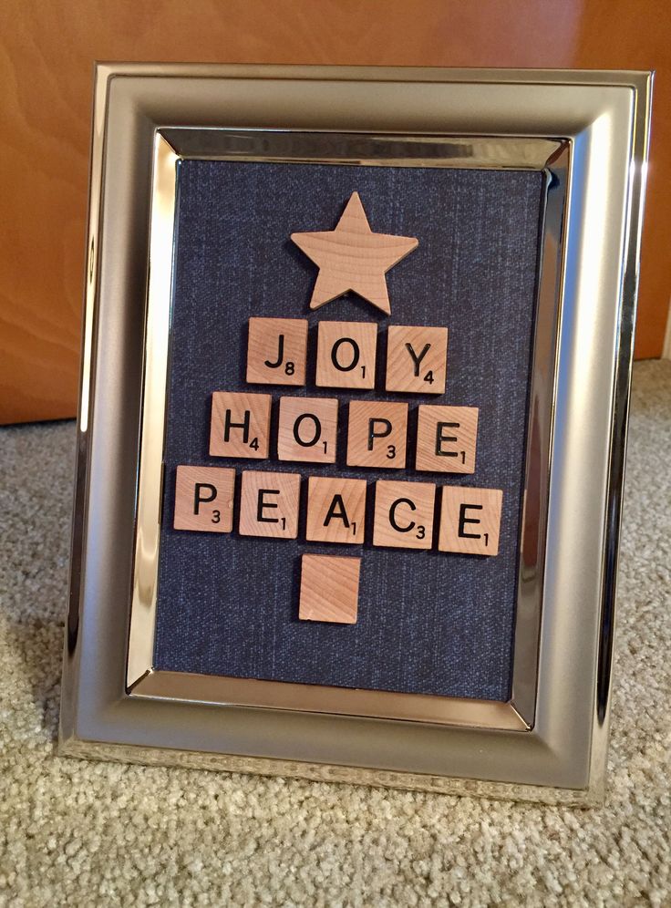 a christmas tree made out of scrabble tiles with the words joy, hope, peace