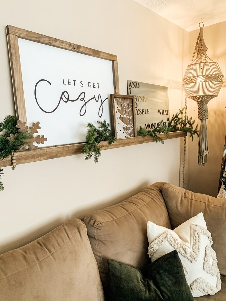 a living room filled with furniture and decor on top of a wooden shelf next to a christmas tree