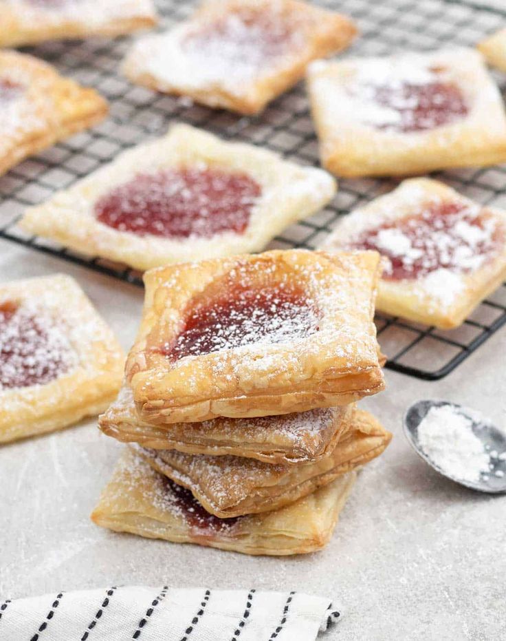 powdered sugar filled pastries cooling on a wire rack