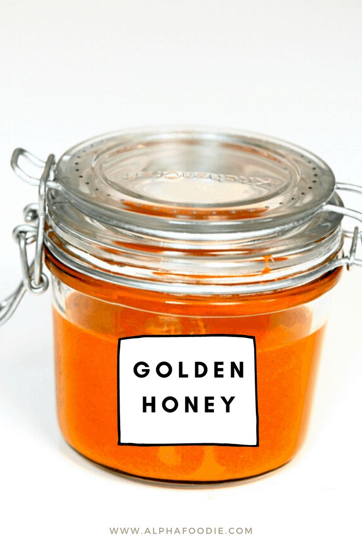 a jar filled with honey sitting on top of a white table