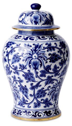 a blue and white vase with a lid