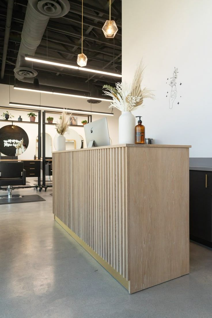 the reception desk is made from plywood and has gold trimmings on it