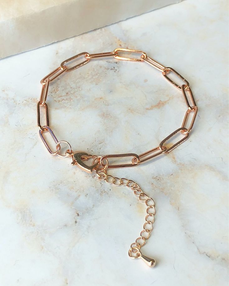 Crafted in 14K rose gold, this elongated link paperclip chain bracelet measures 7 1/2" inches with a 2" extender chain and secures with a heart shaped lobster claw clasp. Metal Paperclip Chain Bracelet, Rose Gold Chain Link Jewelry With Lobster Clasp, Rose Gold Oval Link Paperclip Bracelet For Everyday, Rose Gold Oval Link Bracelet With Adjustable Chain, Adjustable Rose Gold Paperclip Bracelet, Rose Gold Oval Link Paperclip Bracelet, Everyday Rose Gold Paperclip Bracelet With Oval Links, Everyday Rose Gold Oval Link Paperclip Bracelet, Trendy Rose Gold Bracelet With Delicate Chain