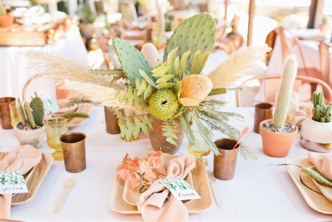 a table topped with lots of different types of flowers and succulents in vases