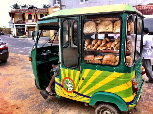 an auto rickshaw with bread on the back