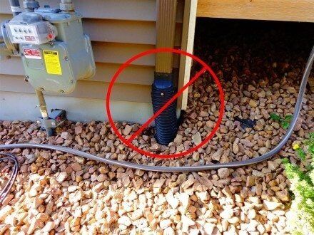 a red circle is in the middle of a garden hose next to an electrical box