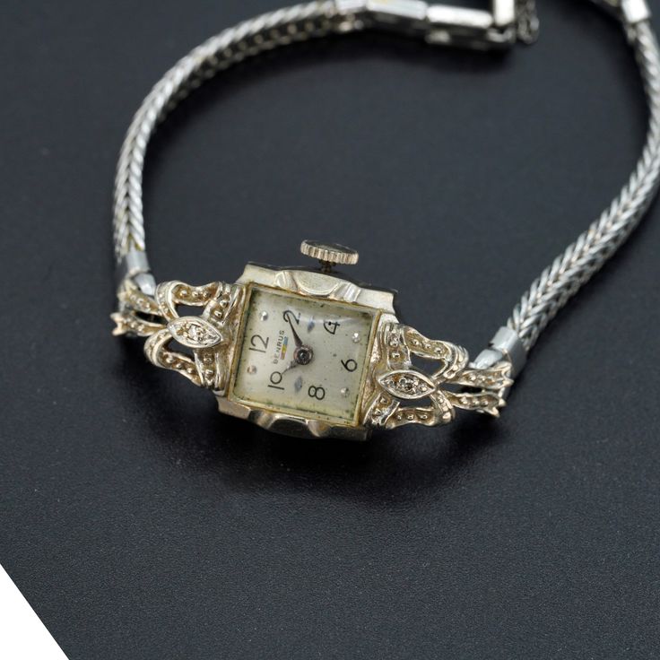 Vintage antique Benrus ladies watch 14k white gold case.  Watch is in working condition. Wind up watch. Fold over clasp with saftey chain. Weighs approx. 14.60 grams This is genuine 14k gold case and 10k gold filled strap. Watch is approx. 15mm in width. There are two diamonds on the case as well. ⭐️⭐️⭐️  MAIN SHOP PAGE ⭐️⭐️⭐️ www.etsy.com/shop/ronnie7 ⭐️⭐️⭐️  ABOUT PAGE ⭐️⭐️⭐️ www.etsy.com/shop/ronnie7/about ⭐️⭐️⭐️  PENDANT SECTION ⭐️⭐️⭐️ www.etsy.com/shop/Ronnie7?section_id=11397068 ⭐️⭐️⭐️ VIN Vintage 14k Stamped Jewelry For Formal Occasions, Evening Yellow Gold Jewelry With Box Clasp, Antique Yellow Gold Watch For Evening, Antique Yellow Gold Watches For Evening, Antique Yellow Gold Evening Watch, Art Deco Gold Watches For Evening, Art Deco Formal Jewelry With Screw Back, Yellow Gold Art Deco Evening Watches, Antique Screw Back Jewelry For Formal Occasions