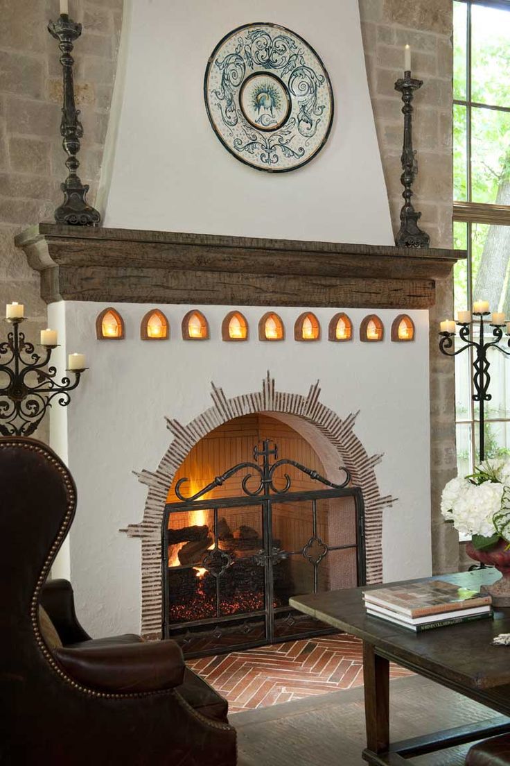 a living room filled with furniture and a fire place in front of a clock on the wall