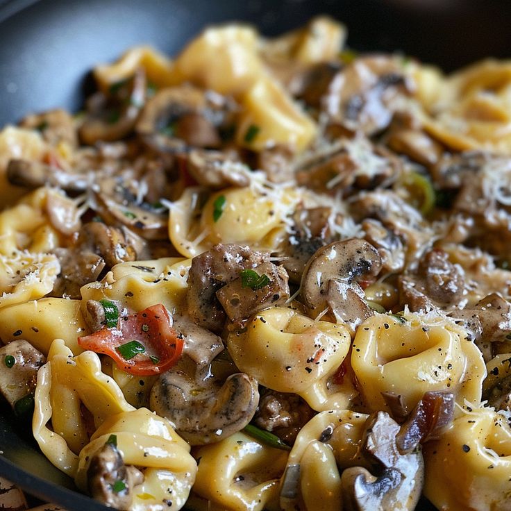 pasta with mushrooms and peppers in a skillet