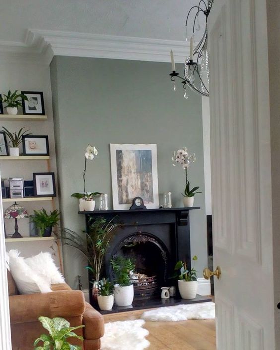 a living room filled with furniture and a fire place next to a doorway that leads to a sitting area