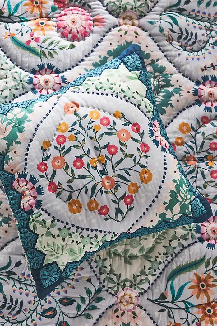 a close up of a quilt with flowers on it