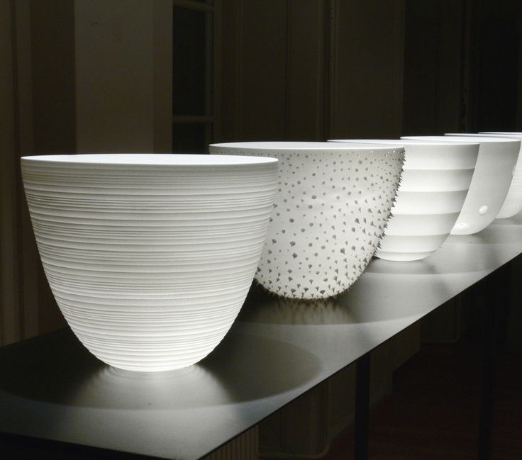 three white bowls sitting on top of a counter