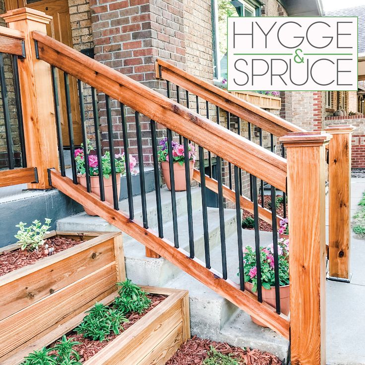 a wooden stair case with flowers on the bottom and plants in pots at the bottom