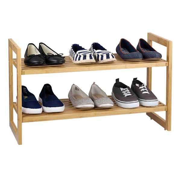 several pairs of shoes are lined up on a wooden shoe rack with two shelves holding them