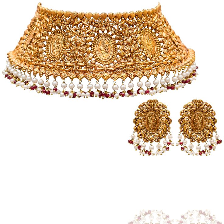 Perfect for grand occasions - adding a touch of opulence and grace, making every moment feel unforgettable! Adorn yourself with this exquisite hand-embellished set, where elegance meets timeless craftsmanship. Intricately designed with ornate floral motifs and adorned with delicate pearl and ruby accents, this regal set radiates a majestic allure. The set includes a necklace and a pair of earrings. Approximate earrings length is 2". Gold-plated on high-quality brass as base metal. Made by order. Kundan Sets For Formal Occasions In Temple Jewelry Style, Elegant Kundan Formal Sets, Elegant Kundan Sets For Formal Occasions, Elegant Kundan Sets For Ceremonial Occasions, Intricate Design Jewelry Sets For Receptions, Festive Temple Jewelry Sets For Formal Occasions, Elegant Meenakari Bridal Necklace, Formal Festive Temple Jewelry Sets, Elegant Gold Sets For Reception