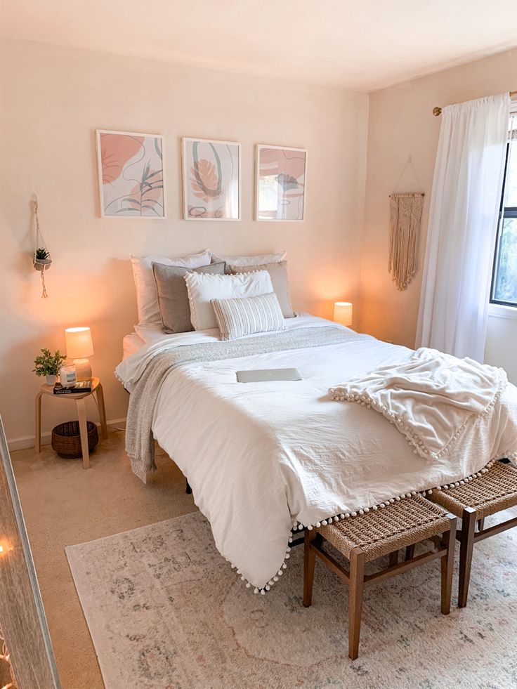 a white bed sitting next to a window in a bedroom on top of a rug