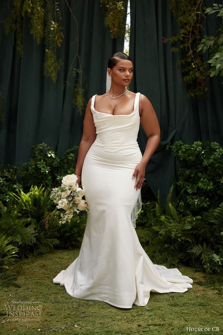 a woman in a white wedding dress posing for the camera