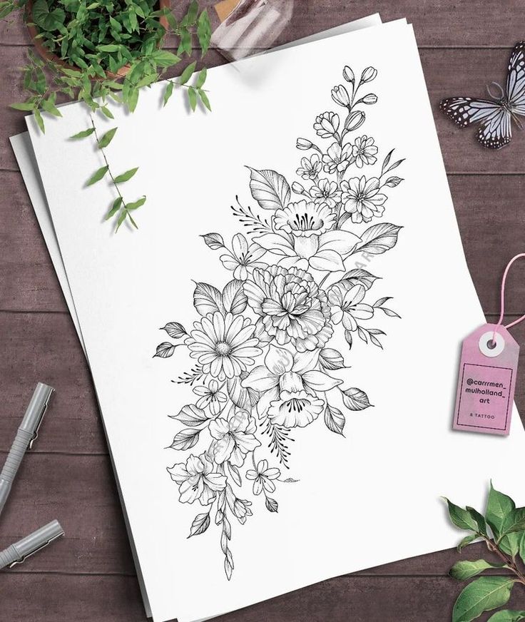 a card with flowers on it next to some scissors and other items that include pens