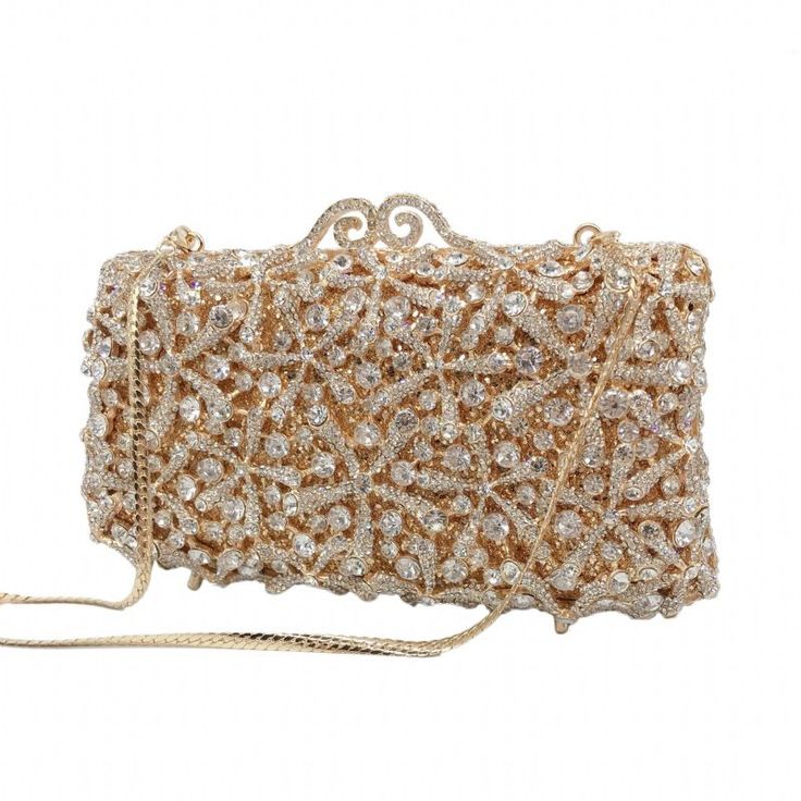 Description: ROSY Clutch is the perfect accessory for any formal occasion. This elegant piece features a crystal clutch design, ensuring it will make a sophisticated statement wherever it goes. Perfect for pairing with any ensemble, the ROSY Clutch adds a touch of glamour to any look. Color - Gold | Lining Material: Synthetic Leather Detachable Chain Included Approximate Size: 17-1/2cm (L) x 5cm (W) x 10cm (H) Crystal Evening Bag With Bling For Party, Crystal Bling Evening Bag For Party, Crystal Clutch With Rhinestones For Party, Glamorous Crystal Clutch For Party, Elegant Rectangular Jewelry For Evening, Embellished Crystal Clutch For Evening, Embellished Crystal Evening Clutch, Chic Embellished Crystal Evening Bag, Embellished Crystal Evening Bag For Formal Occasions