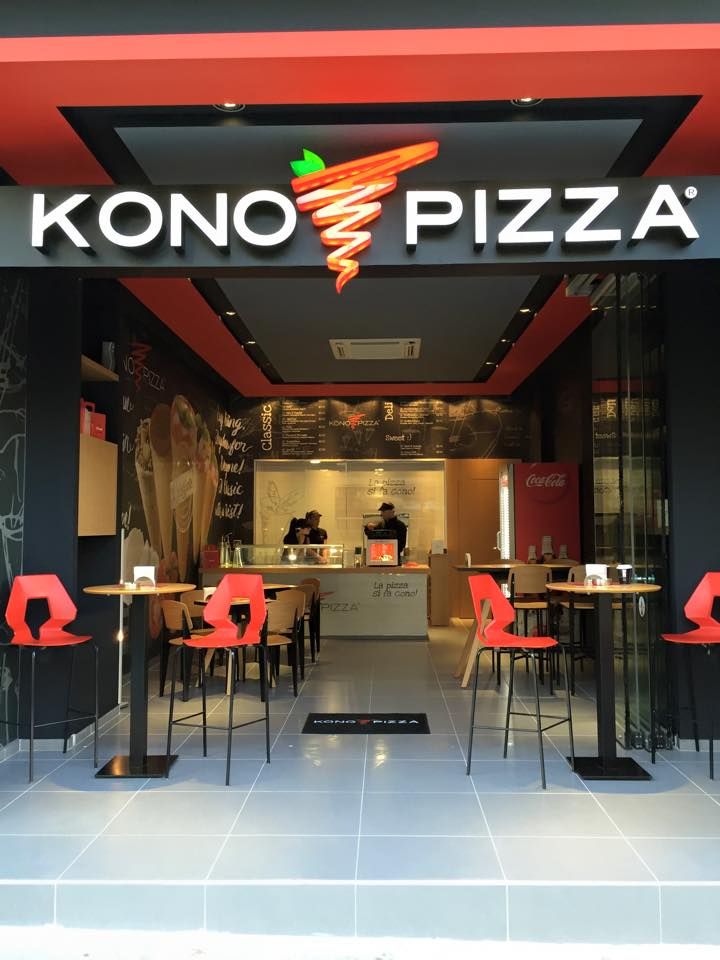 the front entrance to kono pizza with red chairs and tables in front of it