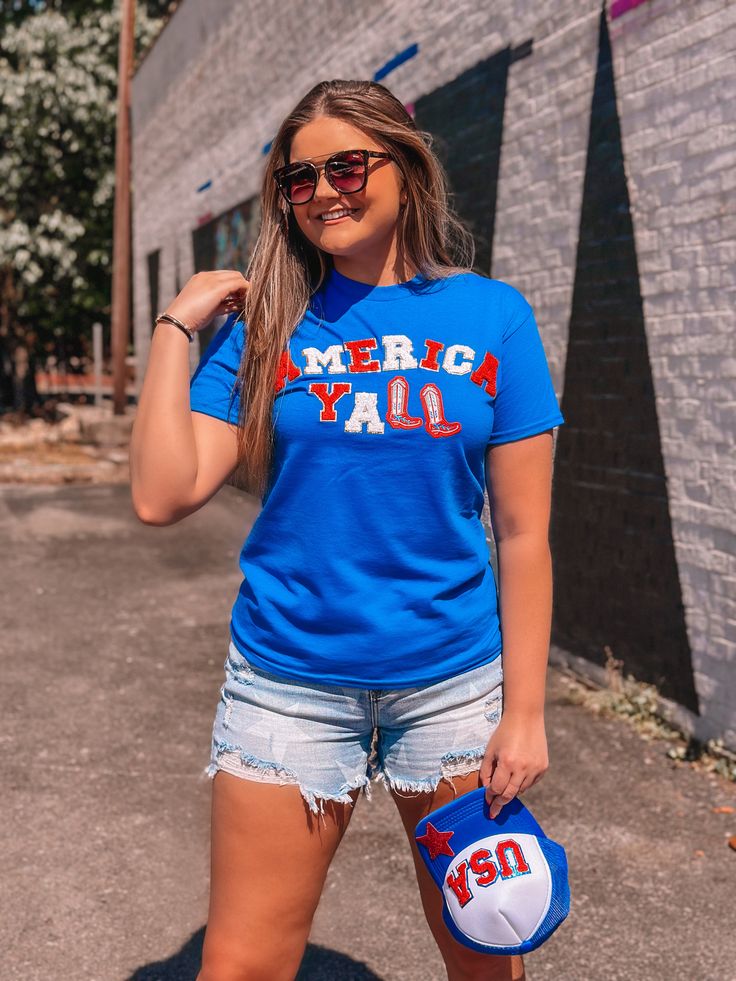 Show your patriotism in style with this AMERICA YALL Chenille Royal Blue T-Shirt. Enhance your country look with the perfect combination of royal blue, red, and white. While being super cute, this chenille tee also represents the southern and country vibes. Perfect for the Fourth of July! Unisex sizing and fit SPECIAL CARE - WASHING INSTRUCTIONS: Hand washing and air drying are always best for these items. Wash on delicate, cold, and inside out. Always air dry to prevent lint from sticking to th American Flag Print Blue Tops, Blue Flag Print Top For Labor Day, Blue Tops With Flag Print For Labor Day, Blue Flag Print Tops For Labor Day, Blue American Flag Tops, Blue American Flag Print Top For Labor Day, Blue Tops With American Flag Print For Labor Day, American Style Blue Tops For Independence Day, American Style Blue T-shirt With American Flag