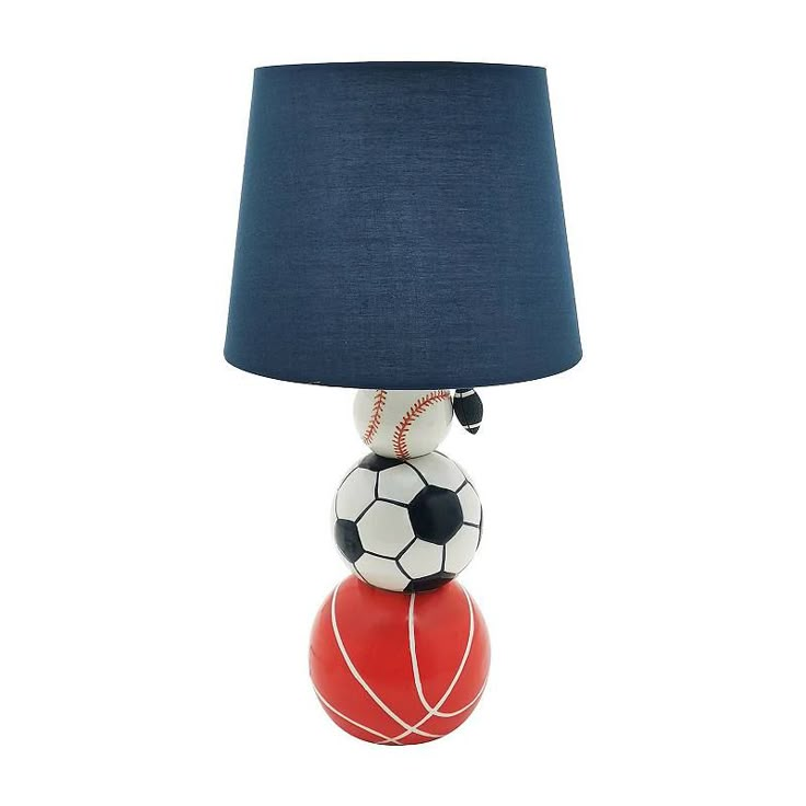 a lamp that is sitting on top of a ball with a soccer ball on it