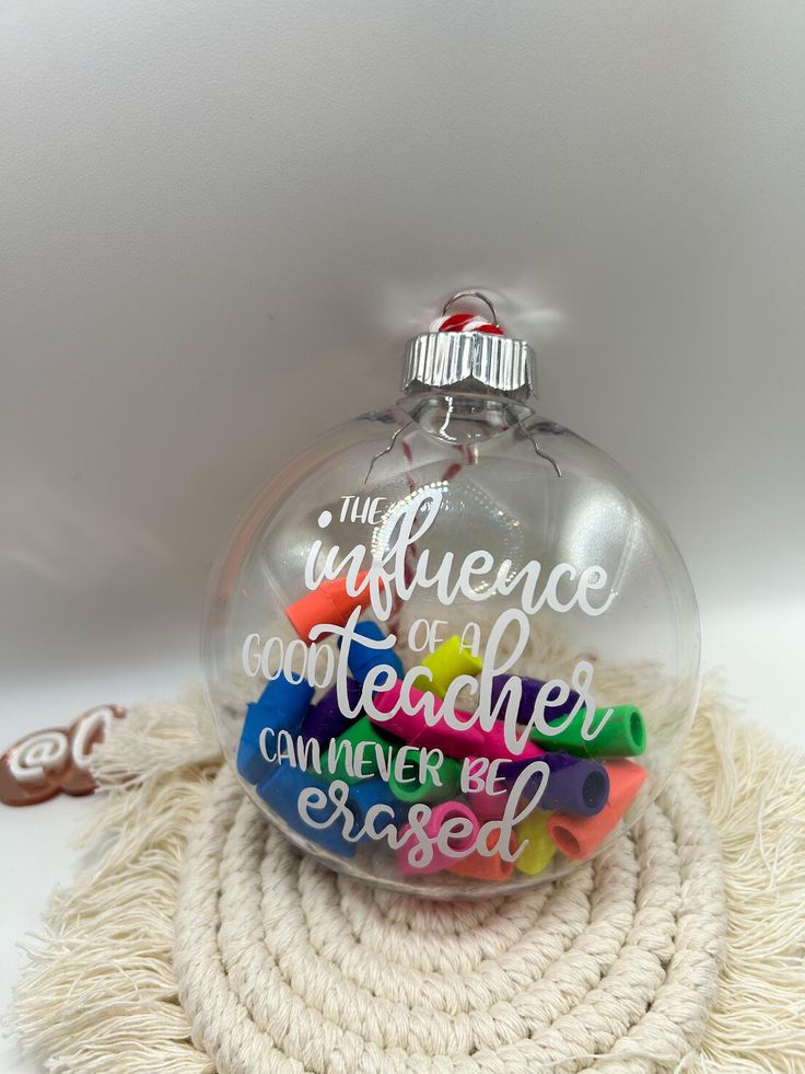 a glass ornament with writing on it