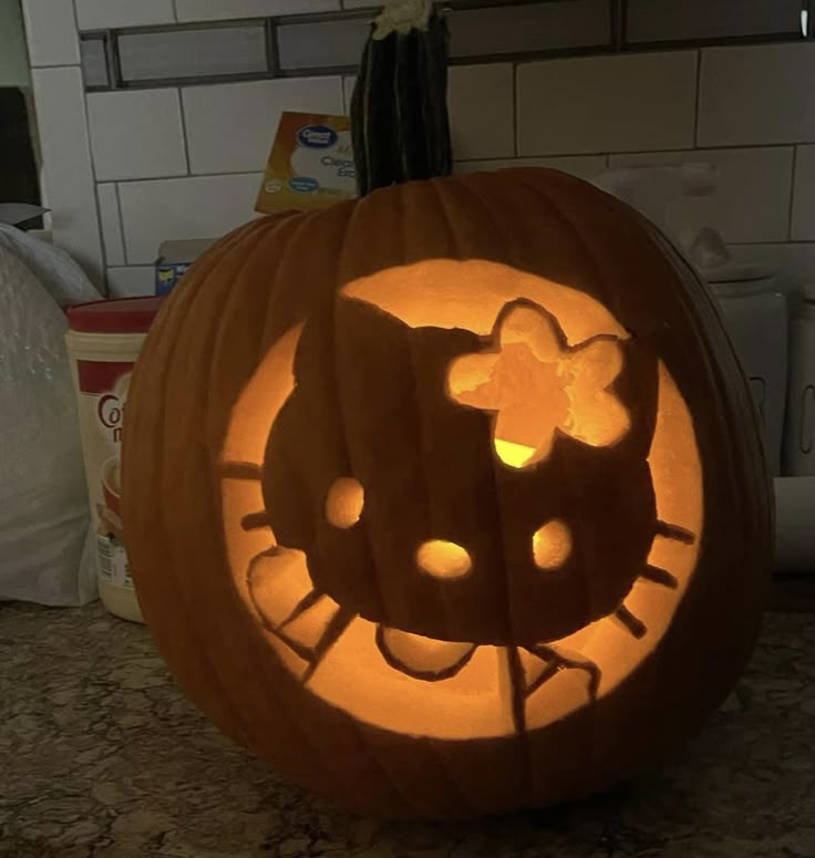 a pumpkin carved to look like hello kitty