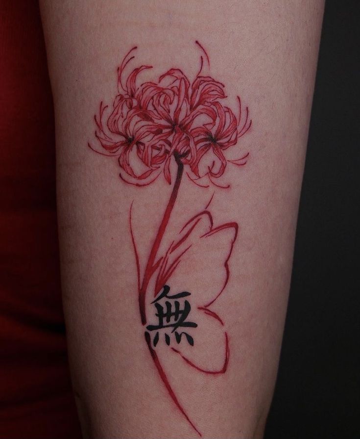 a woman's arm with a red flower tattoo on the left side of her body