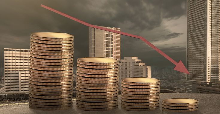 stacks of gold coins sitting in front of a graph up arrow with buildings in the background