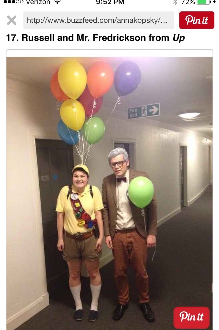 two people standing in an office hallway with balloons attached to their heads and hats on