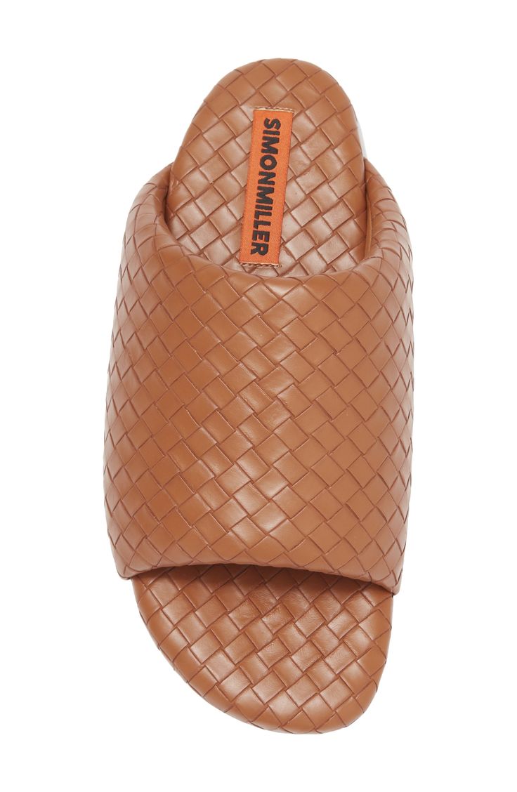 Supple faux-leather strips are woven to form the wide, puffy upper strap of this exceptionally comfortable slide sandal. Textile upper and lining/rubber sole Imported Brown Synthetic Slide Sandals, Brown Synthetic Slides, Designer Leather Slides With Textured Footbed, Luxury Leather Slides, Brown Synthetic Slide Mules, Luxury Brown Sandals With Woven Sole, Comfortable Brown Woven Leather Sandals, Leather Slides With Woven Sole, Leather Slides With Woven Details