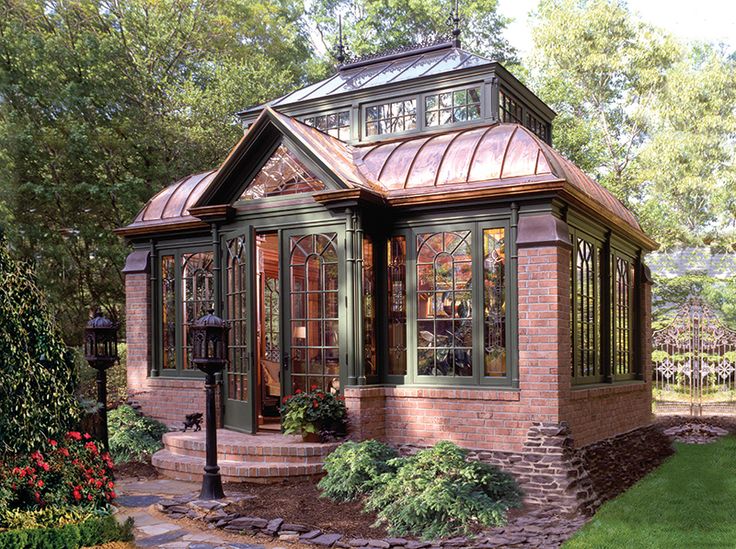 a small brick house with a glass roof