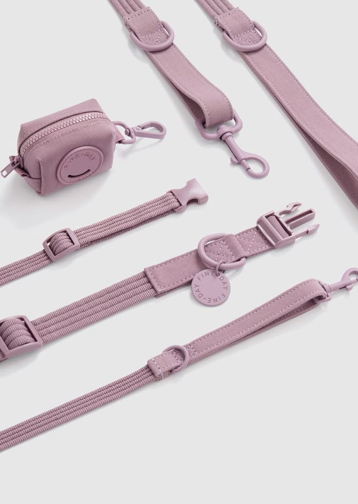 the pink strap is attached to an electronic device and has three clips on each side