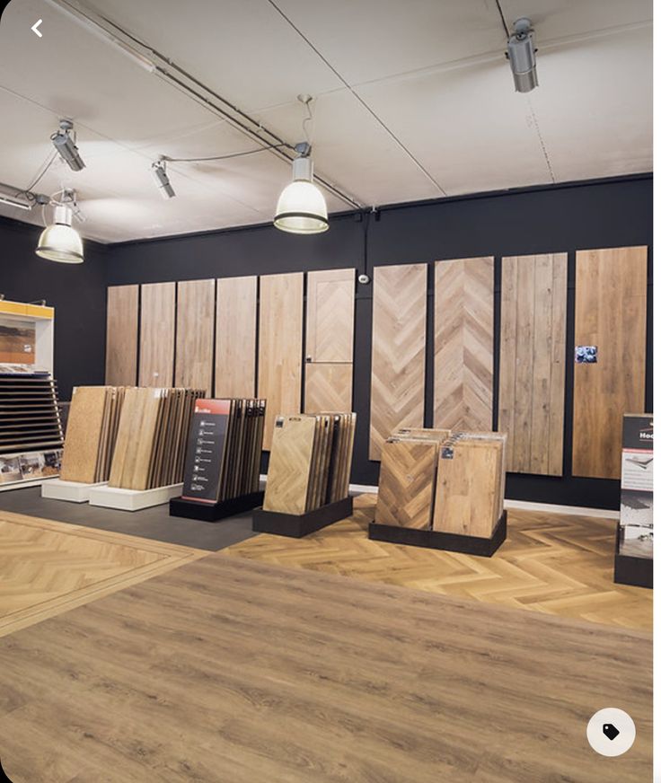 the interior of a building with wood flooring and various types of tile on display