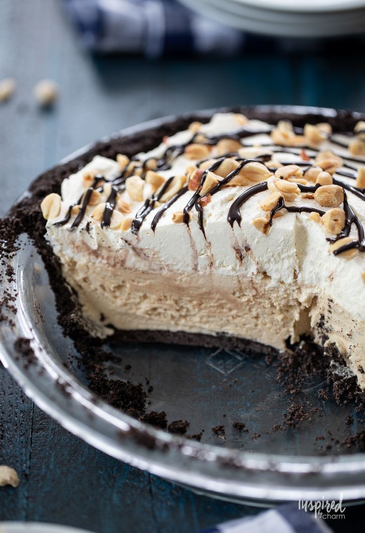 there is a pie with chocolate and nuts on the top, ready to be eaten