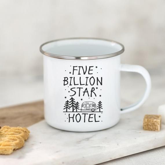 a white coffee mug with the words five billion star hotel on it next to crackers