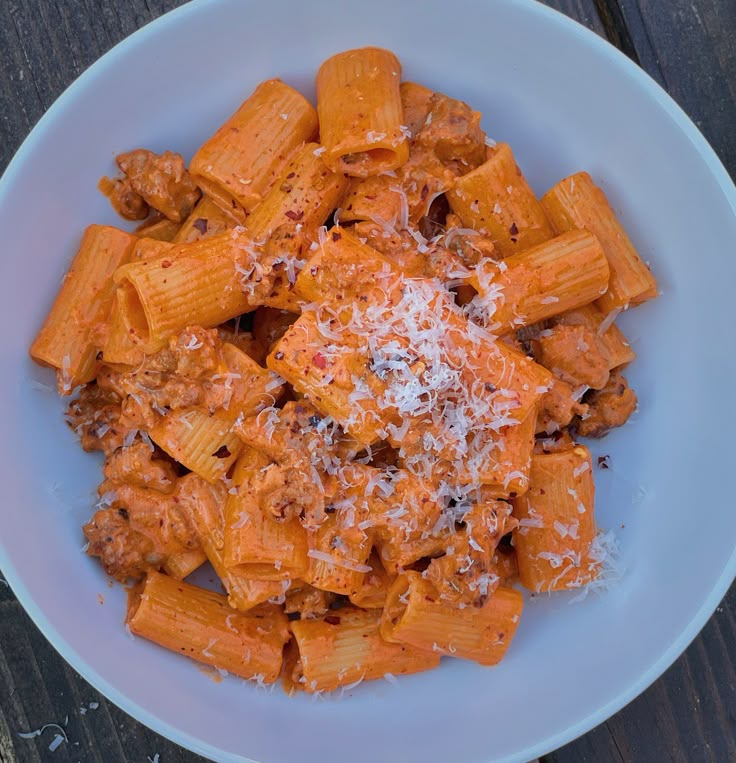 a white bowl filled with pasta and sauce