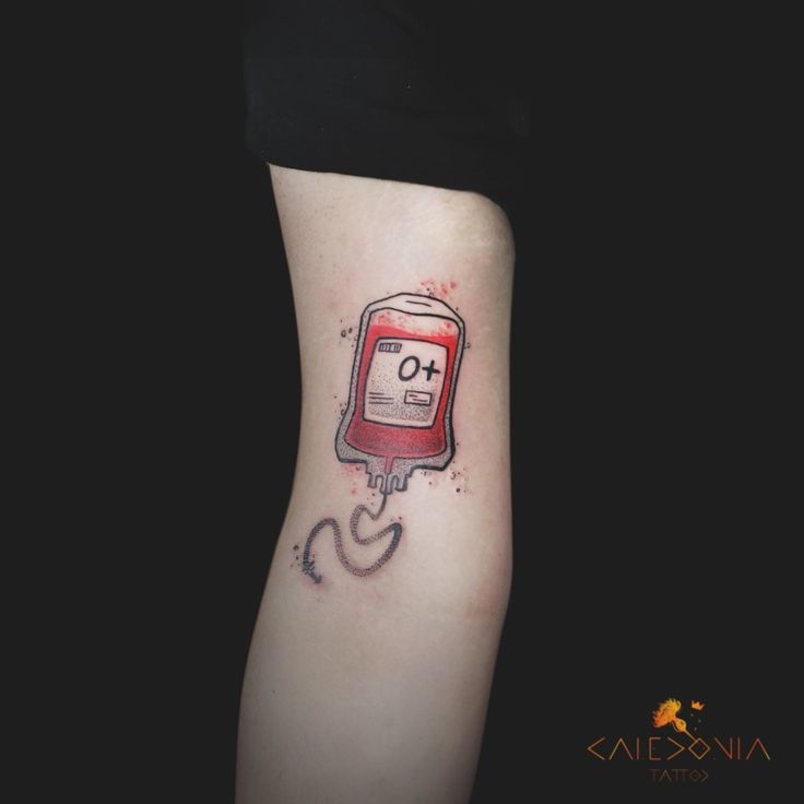 a woman's leg with a tattoo on it that has an image of a blood bag