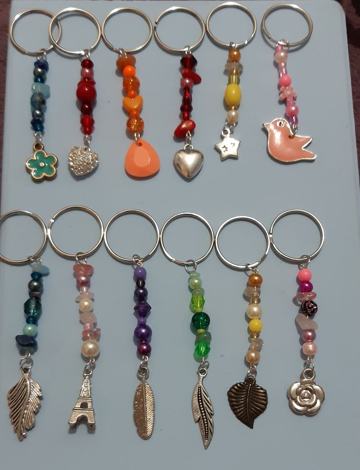 a bunch of different colored beads and charms on a keychain in a box