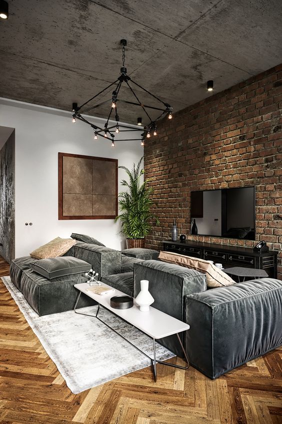 a living room filled with furniture and a brick wall