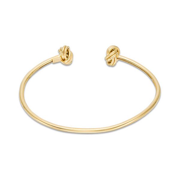 This sweet cuff bracelet is a stylish twist on a fashion classic. Crafted in warm 14K gold, this open look is accented with a pair of textured love knot end designs. Polished to a bright shine and sure to be a constant choice, this flexible 7.0-inch bracelet slips on and off for easy anytime wear. Zales Zales, Peoples Jewellers, Love Knot, 1 Carat, Bracelet Designs, Fashion Bracelets, Cuff Bracelet, Types Of Metal, Heart Ring