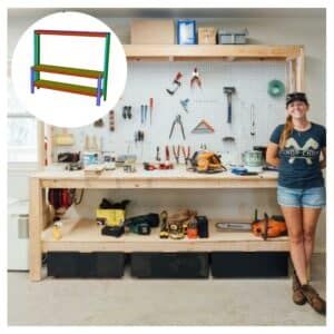 a woman standing in front of a workbench with tools on it