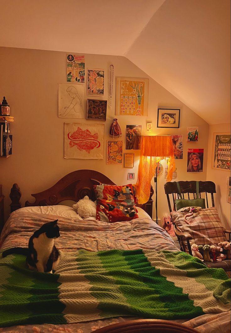 a cat sitting on top of a bed in a bedroom