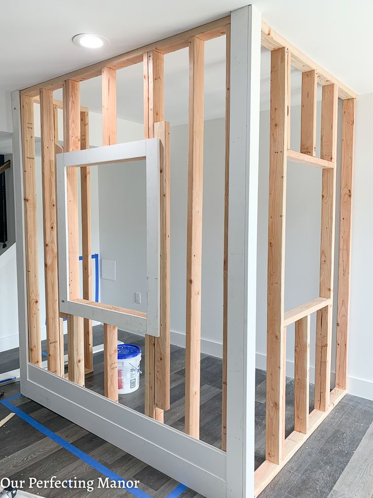 an unfinished room with wood framing on the walls