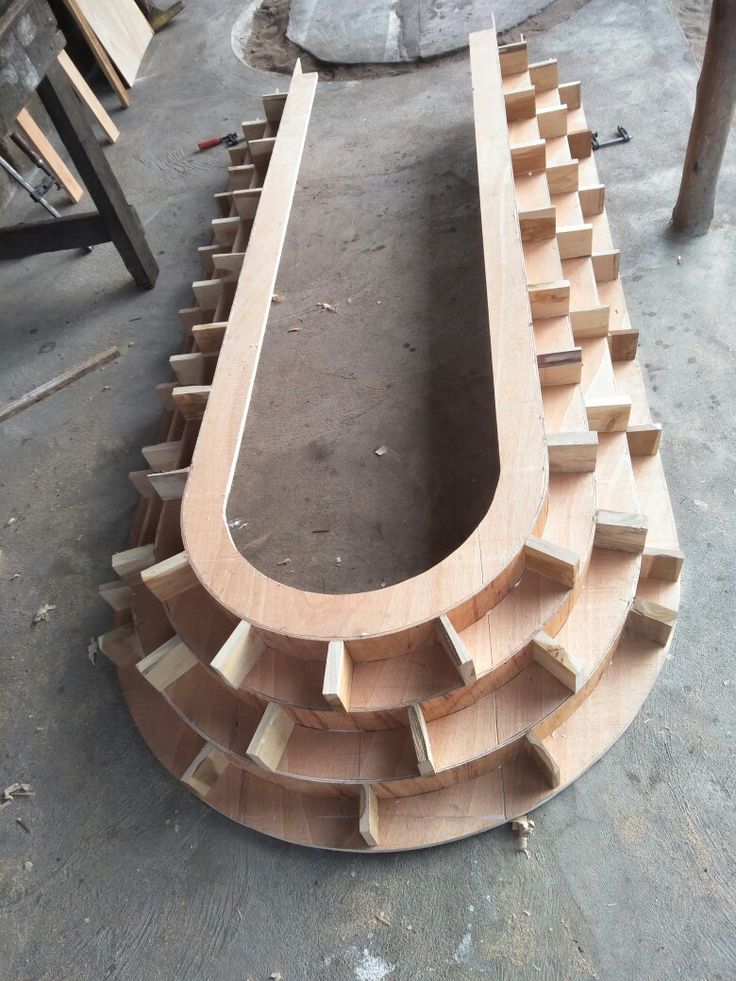 a wooden bench sitting on top of a hard wood floor next to a pile of rubble